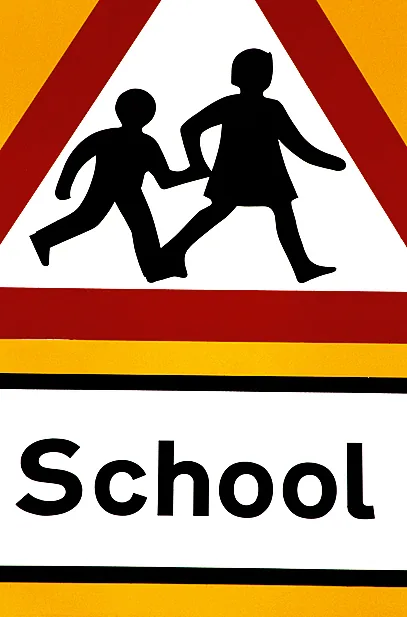 A road sign in front of school A road sign in front of school